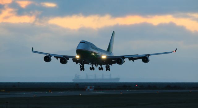 Boeing 747-400 (B-16412) - Twilight approach at YVR 08L from TPE captured with a cargo ship cruising past below