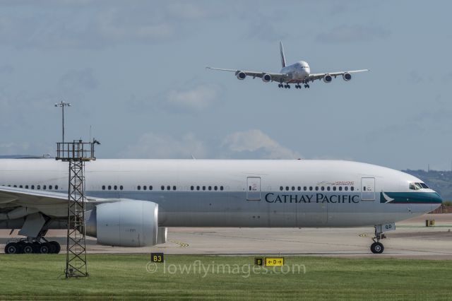 BOEING 777-300ER (B-KQD) - 11 May 2015, Taxiing for departure, with Emirates A380 about to land on runway 23R.