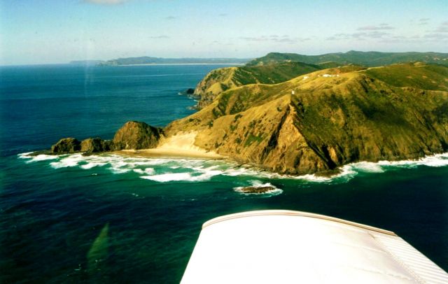 Piper Cherokee (ZK-DUY) - My wife and I orbiting Cape Reinga in the Winter of 1997, at the very top of New Zealand, in the Canterbury Aero Club's Piper Arrow II, ZK-DUY. Taken by my wife with a Nikon F4E and 80-200mm zoom most likely. (I was flying!) We had flown all the way up from Christchurch over 2 days. The furthest you can fly over mainland New Zealand! This was part of my CPL cross country flights, greater than 300nm. Overall, 13 hours flying, 600L Avgas, NZ$2400!