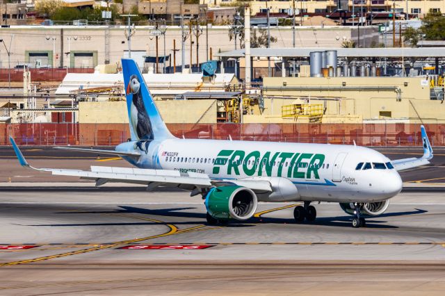 Airbus A320neo (N322FR) - A Frontier Airlines A320 neo "Captain the Puffin" taxiing at PHX on 2/10/23 during the Super Bowl rush. Taken with a Canon R7 and Canon EF 100-400 II L lens.