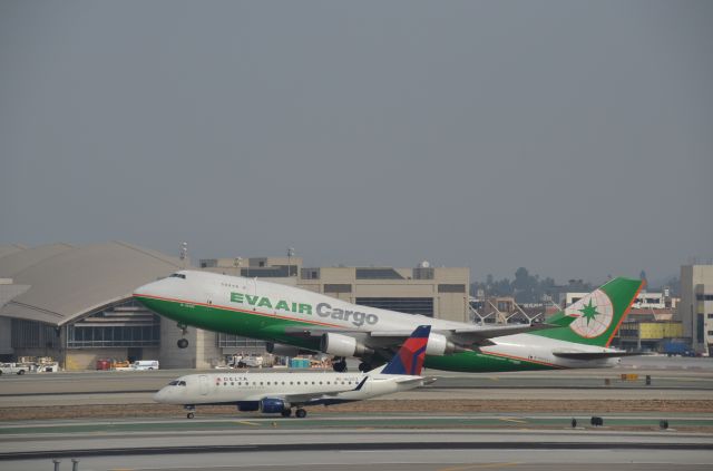 Boeing 747-200 (B-16402) - EVA Air Cargos B-16402 departing LAXs Rnwy 25R as Delta Connection (Compass Airlines) N633CZ, a Embraer 175LR, rolls out after landing on Rnwy 25L.  Photographed from Imperial Hill.