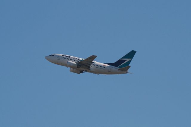 BOEING 737-600 (C-GWSJ) - Departing Montreal Trudeau on runway 06R