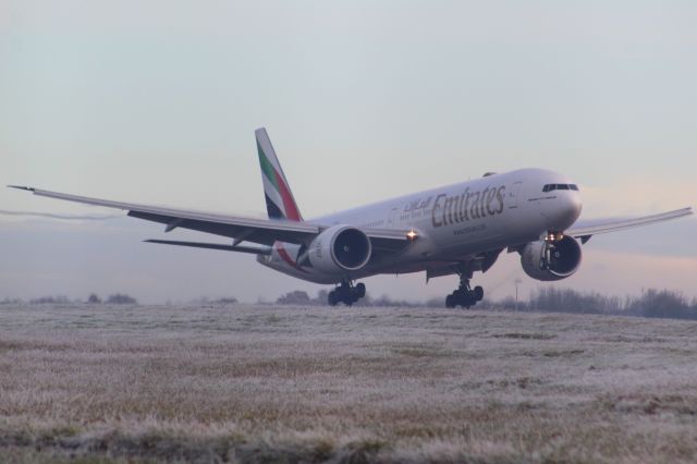 BOEING 777-300ER (A6-EQJ) - An Emirates B777-300ER moments away from landing at Stansted Airport.br /br /Location: Belmer Road, Stansted.br /Date: 11.12.22 (dd/mm/yy).