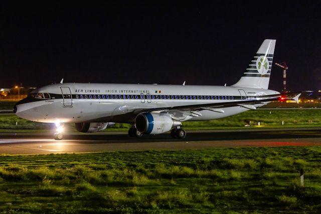 Airbus A320 (EI-DVM) - Exiting to runway 31 for take off at night.