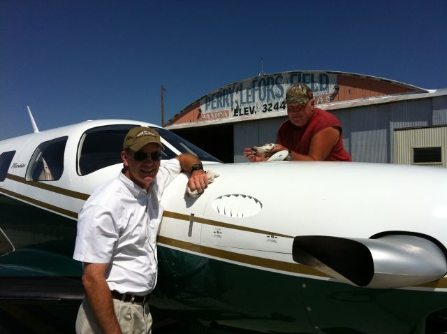 Piper Malibu Meridian (N945LA) - Good old Ron Unruh checks the oil in the Green Hornet.