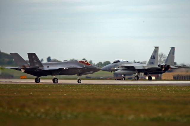 Lockheed F-35C (14-5904) - Present and future.  F-35A on deployment to Lakenheath, Suffolk, UK, holding short as F-15C starts its takeoff run.