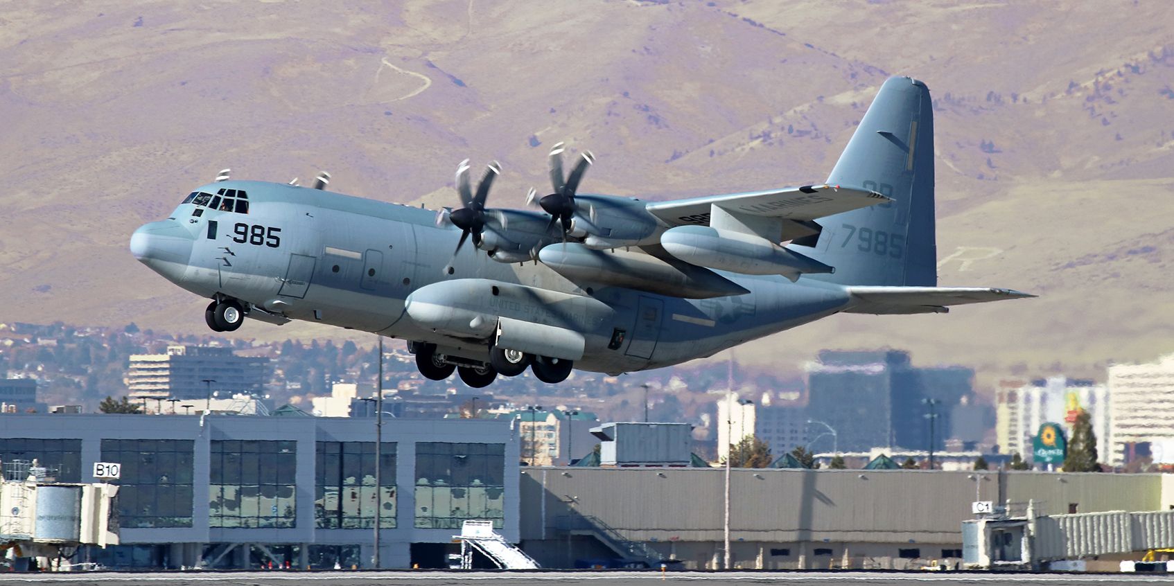 Lockheed C-130 Hercules (16-7985) - A VMGR 352 "Raiders" KC-130J Hercules is on the climb during an afternoon departure.  VMGR 352 (Marine Aerial Refueler Transport Squadron 352) is part of MAG 11, 3rd Marine Air Wing, and is based at MCAS Miramar.