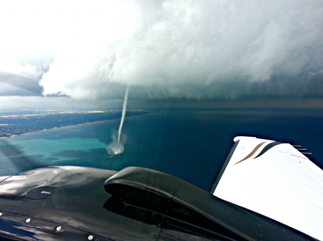 Beechcraft Baron (58) (N524DM) - Water spout offshore @ KUGN  Photo by Ric Menendez