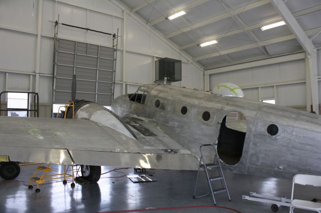 — — - The process of an old Beechcraft in progress.