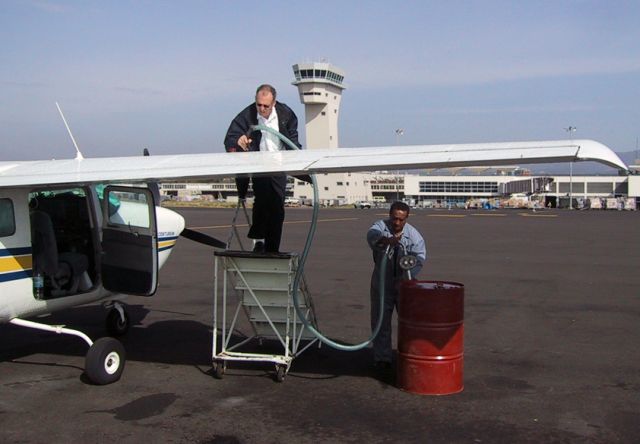 Cessna Centurion (ZS-AVB) - Refuelling AVGAS from drums at Addis Ababa, Ethiopia.