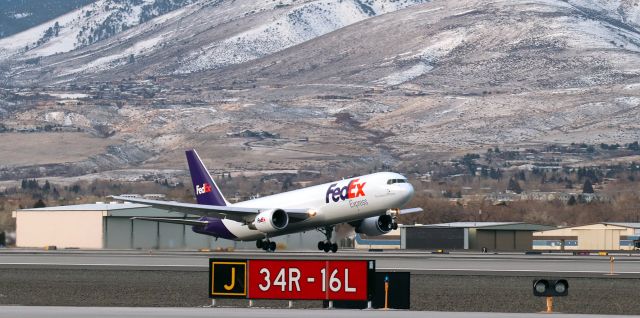 BOEING 767-300 (N185FE) - "Christine," a B763 (N185FE), has just lifted off from 34L (*) to begin the return leg of FDX's daily morning KMEM-KRNO-KMEM roundtrip route.br /br /(*) The runway sign in the foreground identifies the concrete runway seen in this pic running between the sign and FDX's "Christine," NOT the runway "Christine" is taking off from. When this photo was taken yesterday morning, 34R-16L was closed so any minor maintenance issues can be addressed and remedied because it (34R-16L) will become the primary runway next month when Runway 34L-16R is closed for the summer.