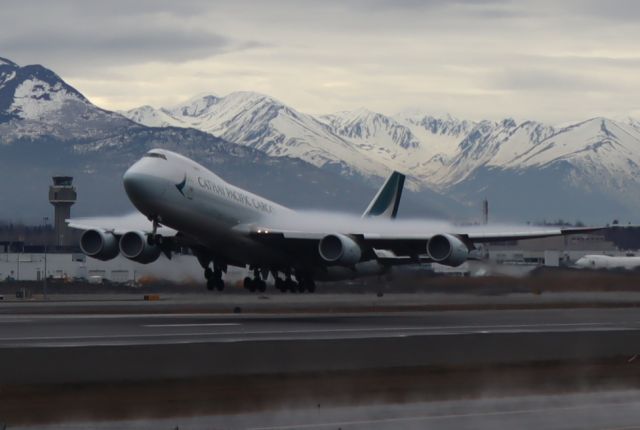 BOEING 747-8 (B-LJC) - Takeoff with condensation clouds on wings, viewed from west side of Runway 15-33