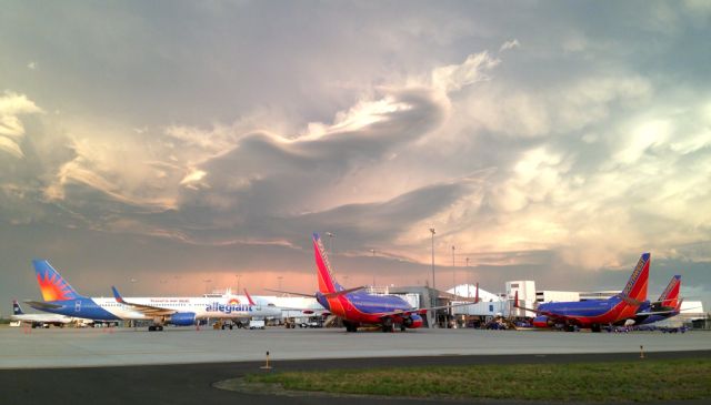 Boeing 757-200 (N901NV) - Morning rush hour here at the airport. The three Southwest Boeing 737-700s prepare for their flights to Denver, Oakland, and Chicago respectively, while the Allegiant Air Boeing 757 prepares for its long flight to Honolulu. In the background under the 757s tail, US Airways Airbus A319 pushes back for its flight to Phoenix.