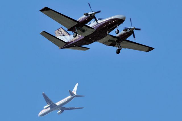 Cessna Conquest 1 (N706LB) - 1/8/12: Cessna Conquest 1 N706LB on short final approach to runway 9-L at Opa-locka Executive Airport with an American Airlines B767-300 on a downwind leg to Miami International in the background.  Photo taken in Golf Course Village section of Miami Lakes.