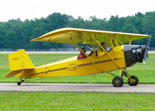 C-GGLU — - At Oshkosh. 1981 Pietenpol Air Camper. Raining and about to depart. At least they have rain gear on. 