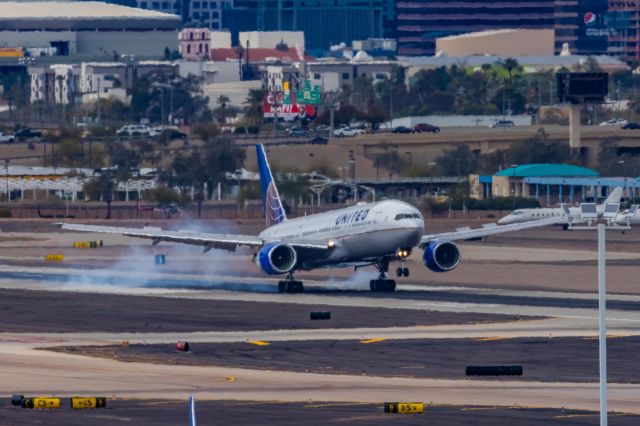 Boeing 777-200 — - A United Airlines 777-200 landing at PHX on 2/13/23, the busiest day in PHX history, during the Super Bowl rush. Taken with a Canon R7 and Canon EF 100-400 II L lens.