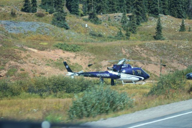 Eurocopter EC-635 (N914SM) - 090715 Care Flight bird on the trailhead on Red Mountain Pass,CO. Out of view are the SAR team vehicles,probably waiting for a recovery and transport down the mountain. 