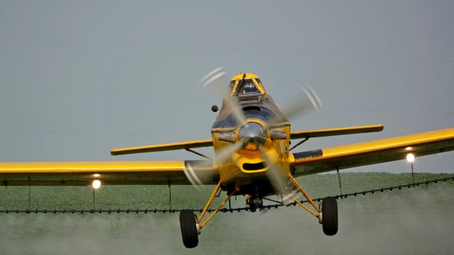 N40110 — - Crop duster in action.