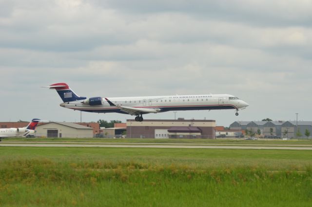 Canadair Regional Jet CRJ-900 (N245LR) - N245LR landing in Sioux Falls SD on Runway 15 on 6-12-15