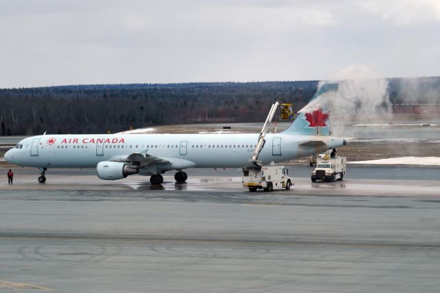 Airbus A321 (C-FGKP) - Deicing on the ground. Massive smoke will suddenly be emitted from the tail of the airplane in a few seconds.(1 of 2, please see my another photo taken just seconds later for the smoke)