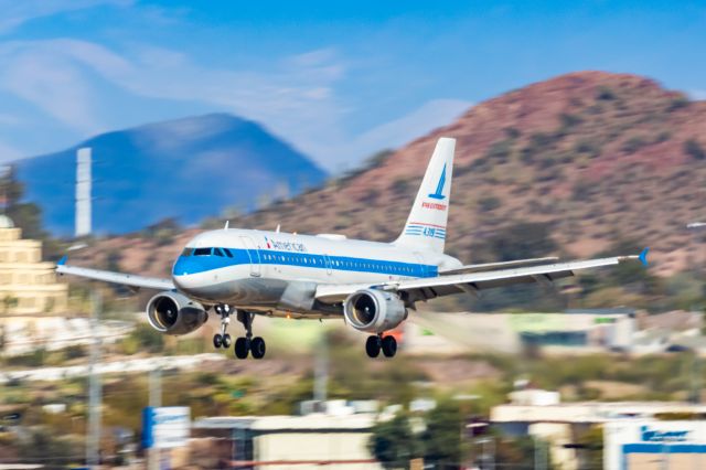 Airbus A319 (N744P) - An American Airlines A319 in Piedmont retro livery landing at PHX on 2/28/23. Taken with a Canon R7 and Canon EF 100-400 L ii lens.