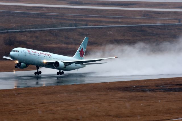 BOEING 767-300 (C-GMWV) - rainy day departure.