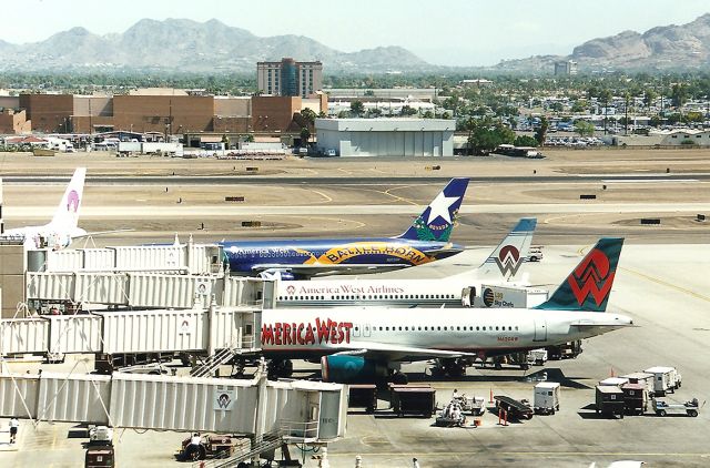 Airbus A320 (N620AW) - KPHX- Now US Airways, these America West Airlines jets back in the good ole days, are lined up for more passengers in this June 1999 view