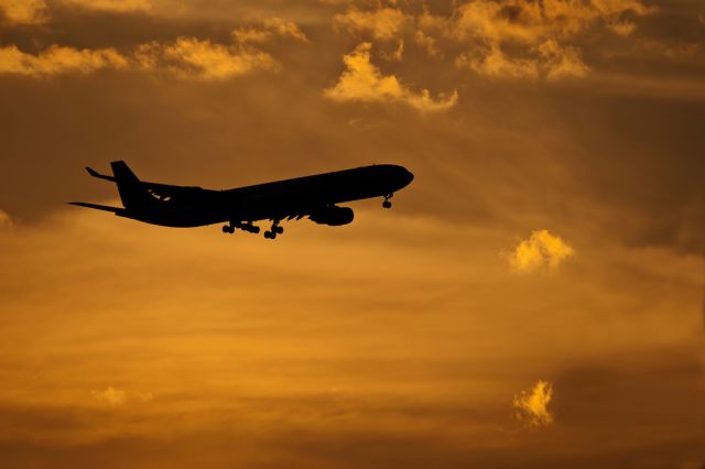 — — - Airbus A340 landing at Sunset