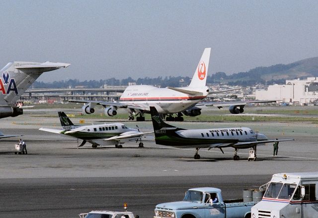 Beechcraft Airliner (N6199D) - KSFO - Wings West Beech 99 Airliner ( L ) along with the Wings West Metroliner ( N606AS) awaiting passengers at SFO - apprx mid 1980s