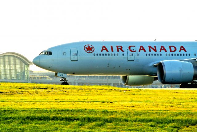 BOEING 777-200LR (C-FNND) - Air Canada 777-200LR beginning roll off of 24R at Pearson