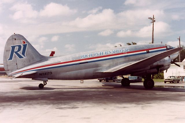 CURTISS Commando (N74173) - Oct. 1982 - Rich International C-46 on its ramp at MIA. Scanned from a print.