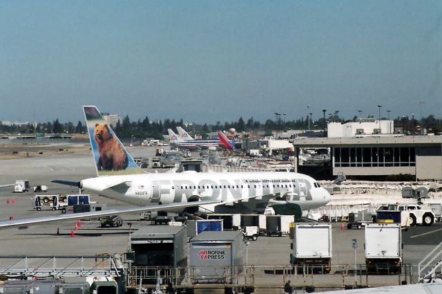 Airbus A318 (N801FR) - KSJC - early AM activity at San Jose - note the old Terminal C and the new Termnal B has not been built yet. View looking north, July 2004