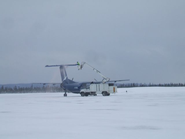 — — - Air Lab Dash 8 being Deiced before take of at Goose Airport NL. April 15/09