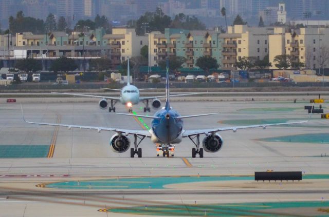 Airbus A320 — - Air Canada and Alaska A320 facing each other.