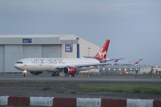 Airbus A330-900 (G-VJAZ) - The first Virgin Atlantic A330-900 holding short of runway 27R. This flight is special as it is the first commercial flight of the type for Virgin Atlantic. This flight was LHR-BOS as VS11.br /br /Location: Northern Perimiter Road, beside runway 27R.br /Date: 27.10.22 (dd/mm/yy).