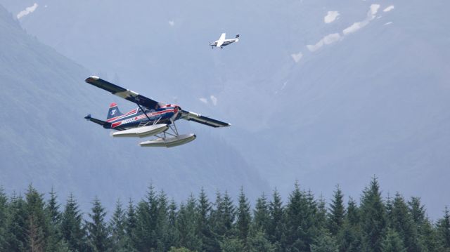 De Havilland Canada DHC-2 Mk1 Beaver (N62353) - N62353 taking off from the float pond with a Caravan in the pattern behind him