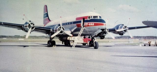 Douglas C-54 Skymaster (VH-INX) - Ansett-ANA DC4 Cargomaster at Flinders Island, circa 1965, Ansett operated DC4s on both freight and passenger flights into Flinders from about 1965 to 1970, along with an occasional Carvair. The freight carried was fish to Melbourne and live lambs to Tasmania and Melbourne