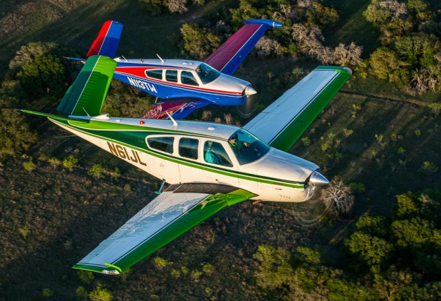 Beechcraft 35 Bonanza (N61JL) - N61JL and N113TW in close formation in the Lake Travis area.  Picture taken by Glenn Watson of Mach Point One Aviation (a rel=nofollow href=http://www.machpointoneaviation.com/http://www.machpointoneaviation.com//a)