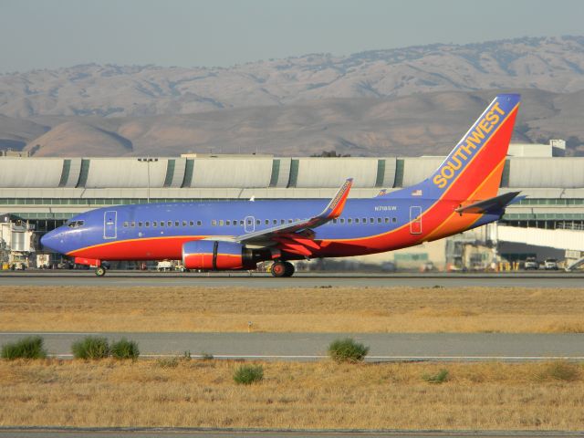 Boeing 737-700 (N718SW) - Before The long term parking lot closed. You could get excellent shots of planes from this spot.