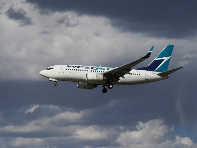 Boeing 737-700 (C-GWBX) - Some dramatic clouds and lighting conditions today made for a wonderful photo opportunity. 