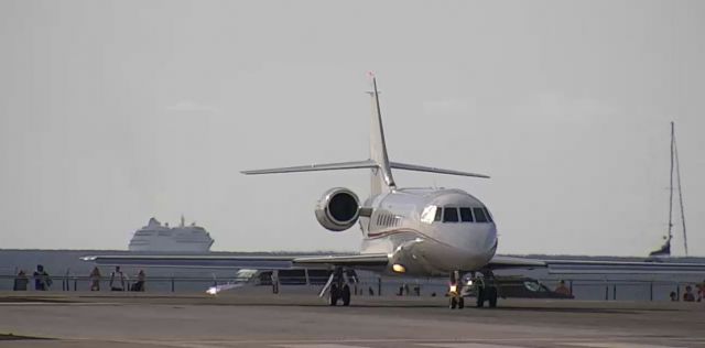 PEREGRINE PJ-3 Falcon (N770QS) - Cool shot of jet getting ready for takeoff with a cruise ship departing