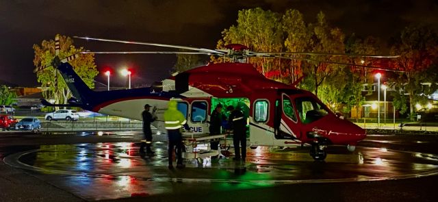 VH-ESZ — - Offloading a patient on a rainy night. 