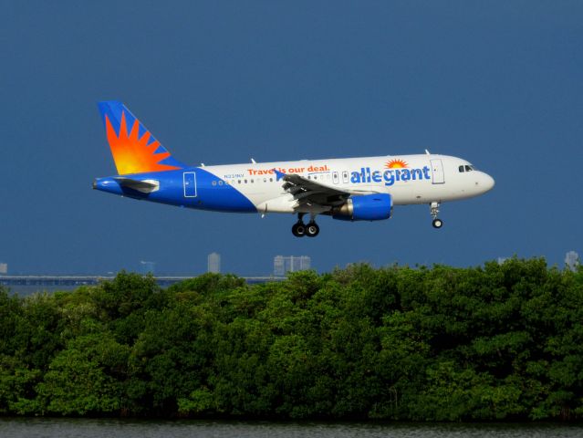 Airbus A319 (N331NV) - Landing at PIE with thunderstorms building in the distance.