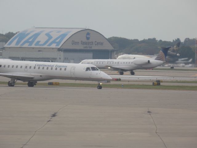 Embraer ERJ-145 (N286SK) - Two Continental titled birds in one shot, never get tired of seeing these.