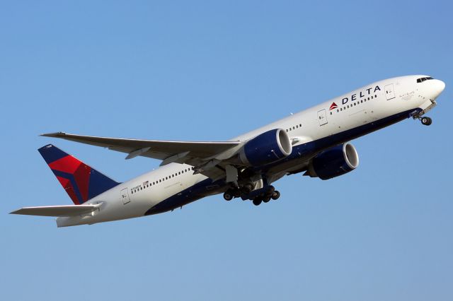 Boeing 777-200 (N708DN) - Commemorative plane for former Delta CEO David C. Garrett Jr blasting away in great morning light!