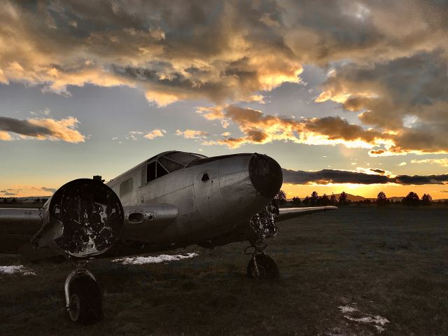 Beechcraft 18 (C-FDWS) - Old Beech 18, been sitting here as long as I can remember. Used to be painted orange back in its airworthy days, and had floats, too. All paint (and the floats) have been removed, and here it sits, with only a mangled SeaBee for company. 