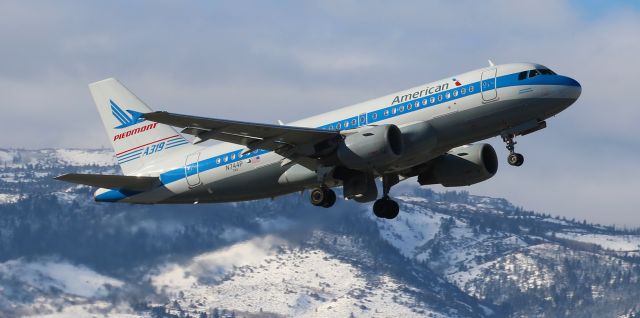 Airbus A319 (N744P) - Americans N744P, displaying Piedmont colors from the past, passes in front of the snowy Sierra Nevada as it heads skyward after lifting off from Reno Tahoe Intls runway 34L.