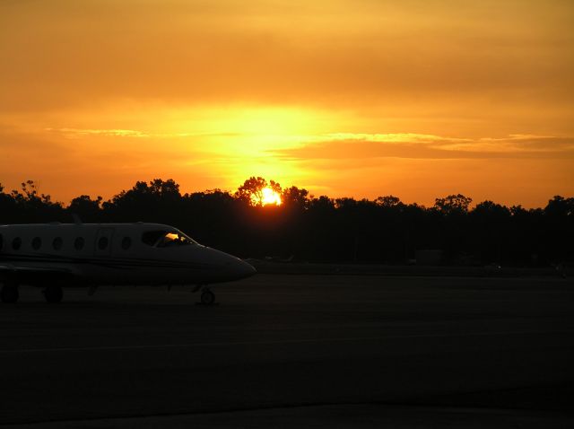 — — - Beechjet on the ramp at BTR during sunrise.