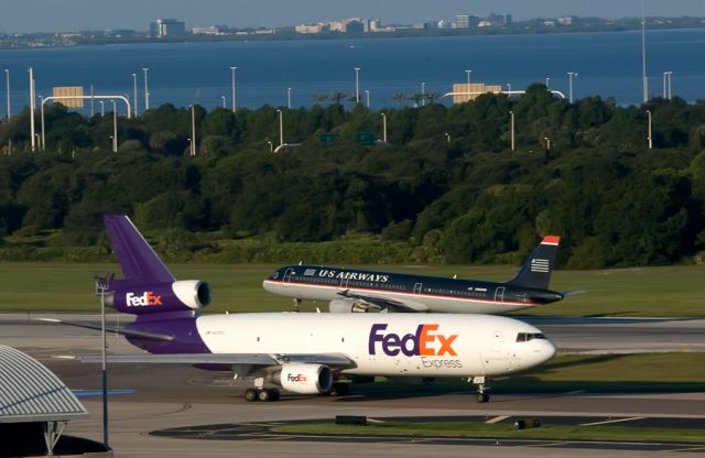 McDonnell Douglas DC-10 (N372FE) - Taxiing while US Air takes off behind