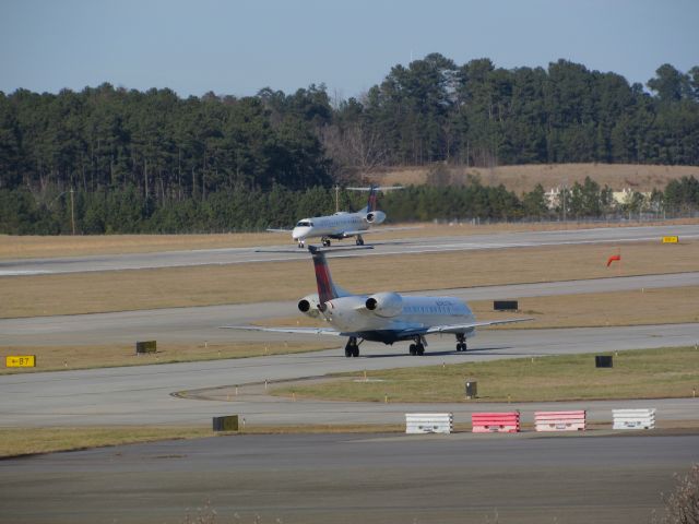 Embraer ERJ-145 — - Two Delta Connection (Shuttle America) Embraer ERJ 145s in one shot taxiing by each other, N571RP taxiing and N286SK lined up for takeoff. Almost like twins! :) Taken January 30, 2016.